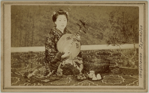 Photograph of a Japanese female musician.  Ca. 1875-80