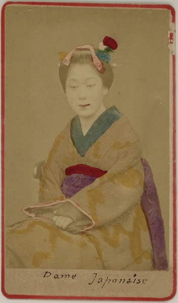 Handcolored photograph of a Japanese woman in kimono.  Ca. 1875-80