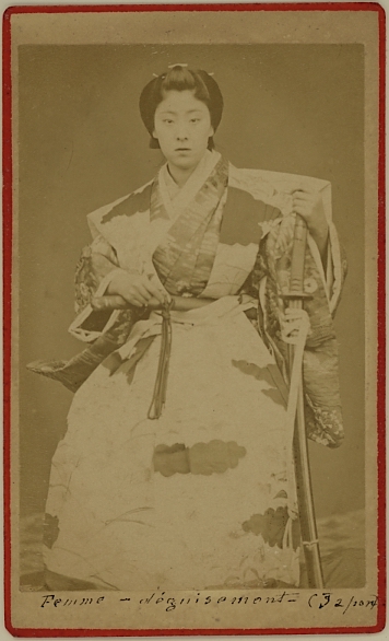 A Japanese female dressed as a samurai. holding a sword.  Ca. 1875-80