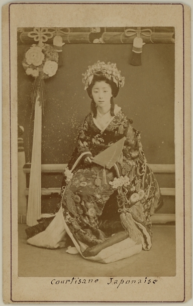 Seated Japanese courtesan in kimono.  Ca. 1875-80
