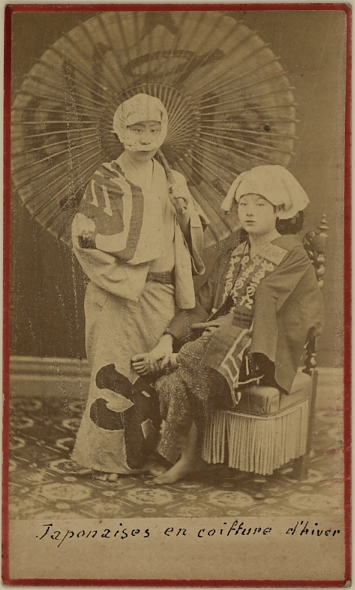 Two Japanese ladies dressed in winter cloths.  Ca. 1875-80
