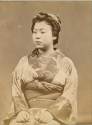 Portrait of a seated Geisha - albumen photograph by unknown photographer 1870's.