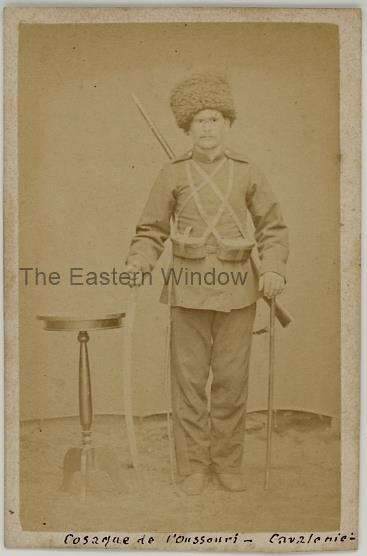 An Ussuri Cossack in full uniform wearing sabre and gun. Ca. 1875-80.