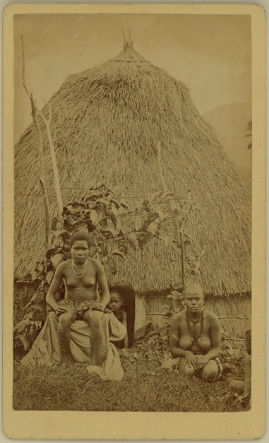 Portrait of two females in front of their house with child in dooropening, New Caledonia - albumen carte de visite by Allan Hughan (1834-1883)