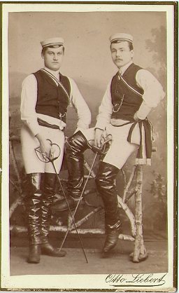 Two students wearing fencing uniform