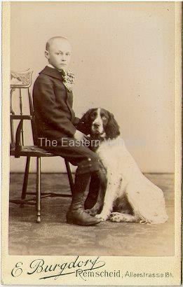 A seated boy with his dog